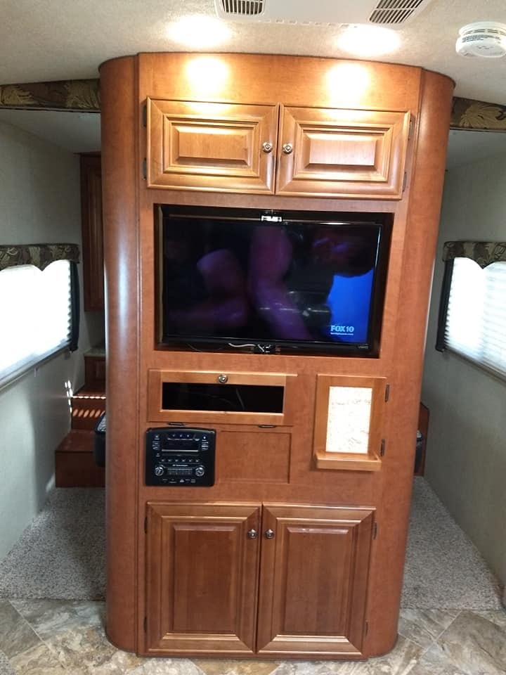 Arctic Fox 28F entertainment center with TV, stereo and wood cabinetry