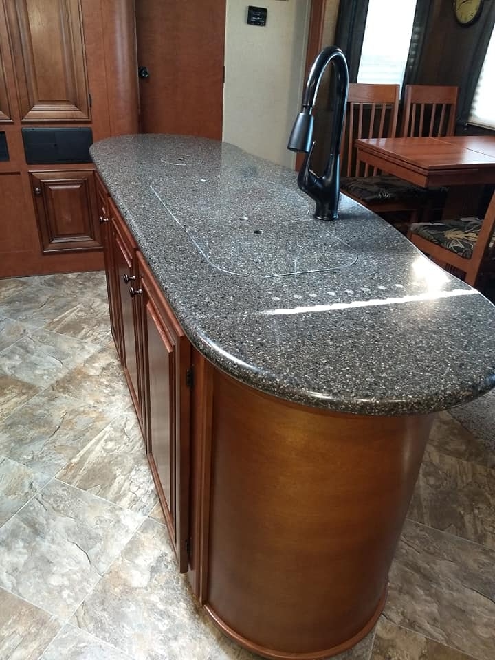 Arctic Fox 28F kitchen island with granite countertop and black faucet