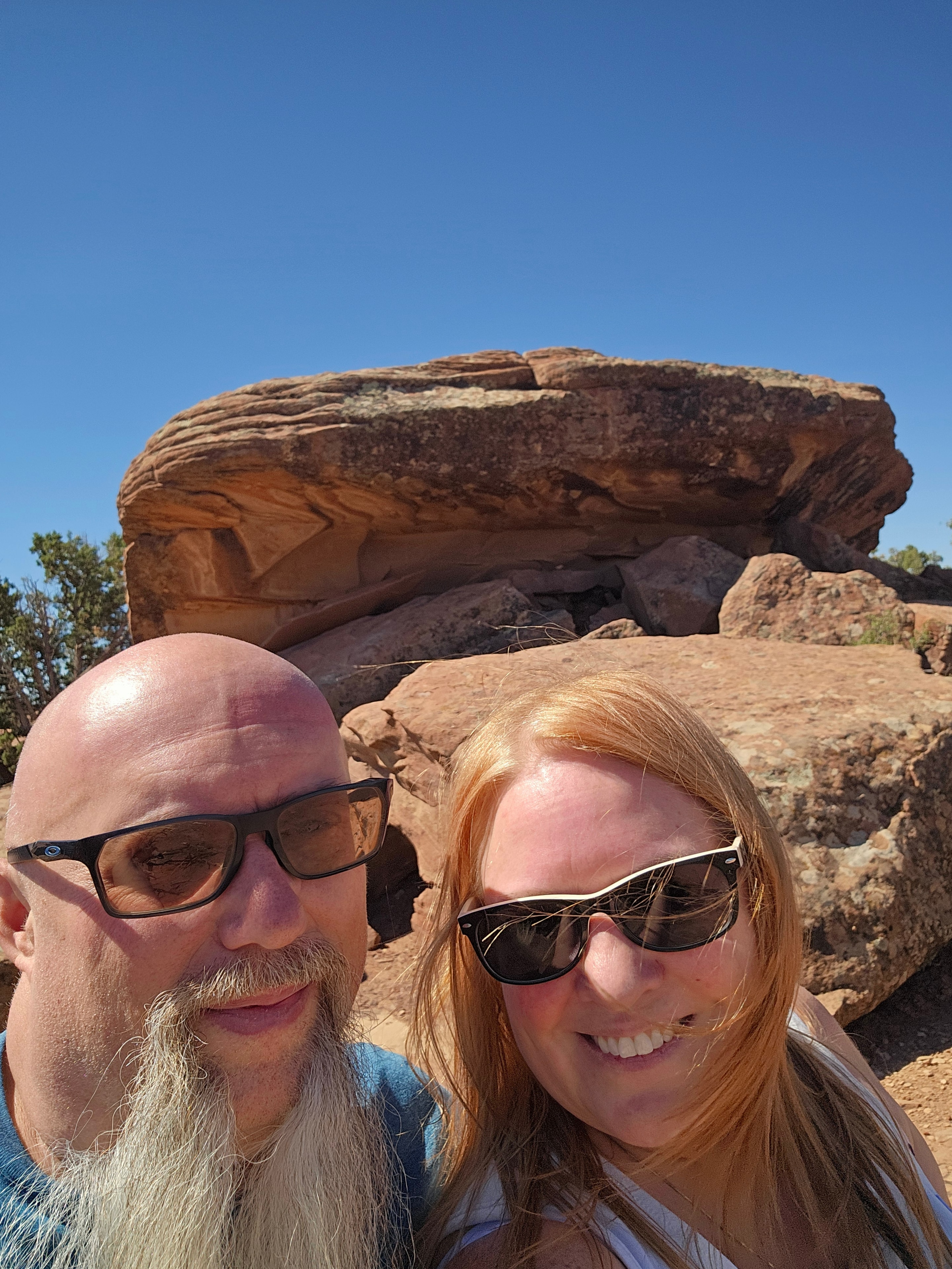 Joe and Tina selfie at Canyon de Chelly — red sandstone background, blue sky — LOVING LIFE HAVING FUN Brinkley Z3400
