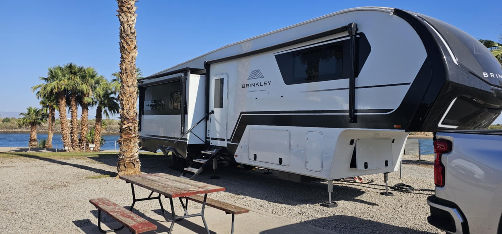 Brinkley Z3400 parked riverside at Ehrenberg Arizona with palms and the Colorado River behind