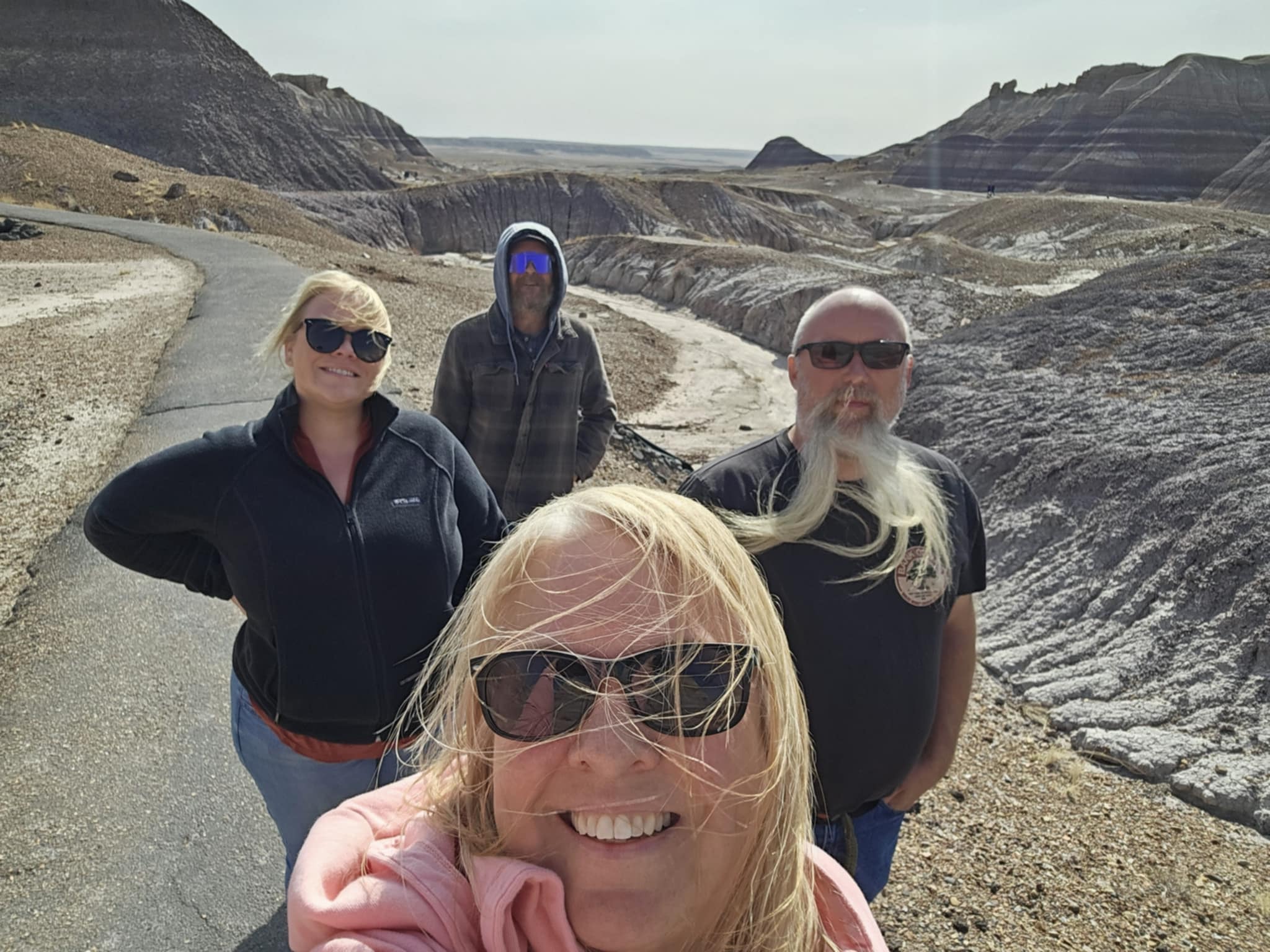 Tina, Shelby, Ben, and Joe selfie on the trail with the Painted Desert badlands stretching behind them at Petrified Forest National Park Arizona