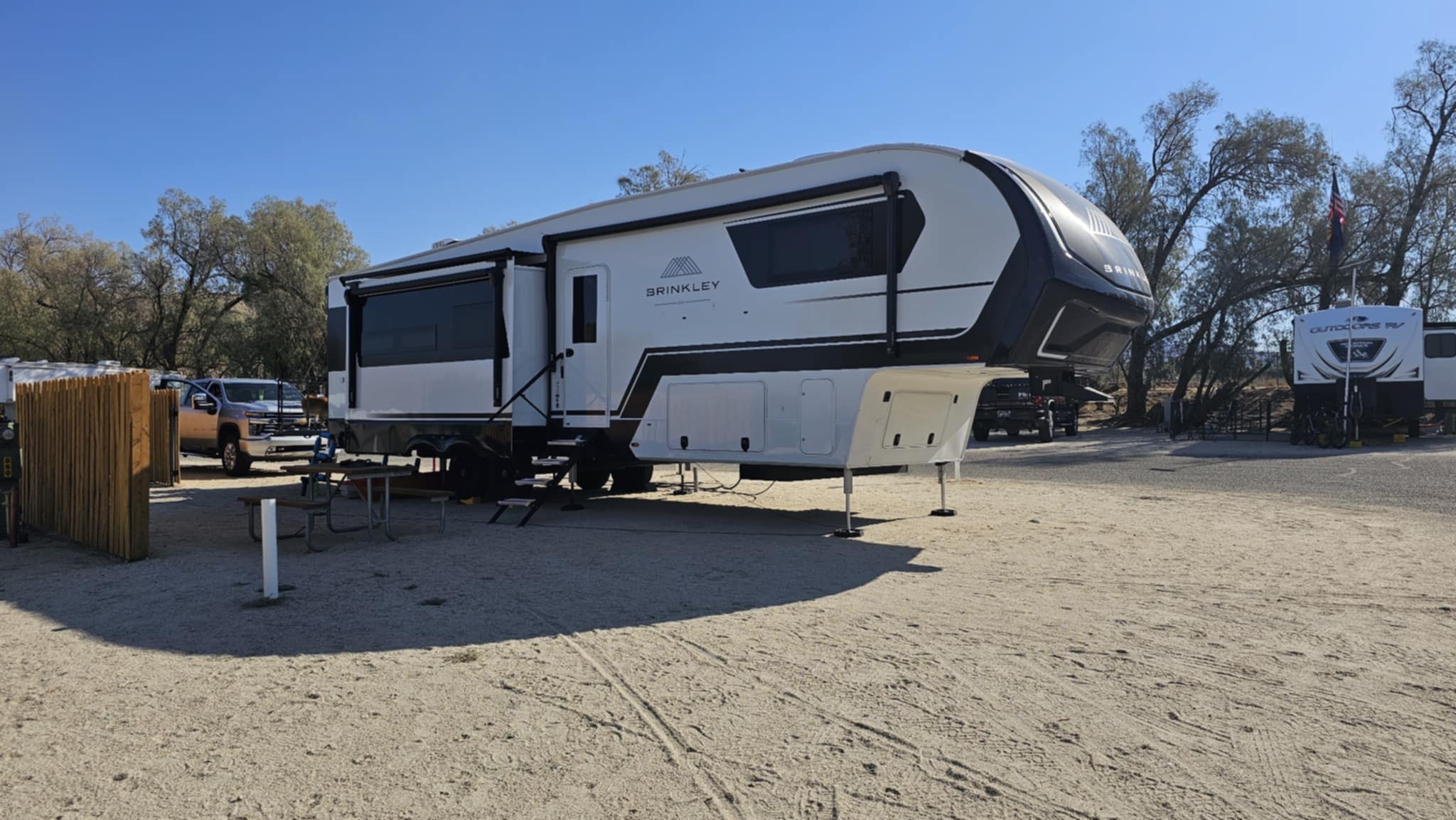 Brinkley Z3400 fifth wheel parked at the KOA Palm Springs campsite under blue skies
