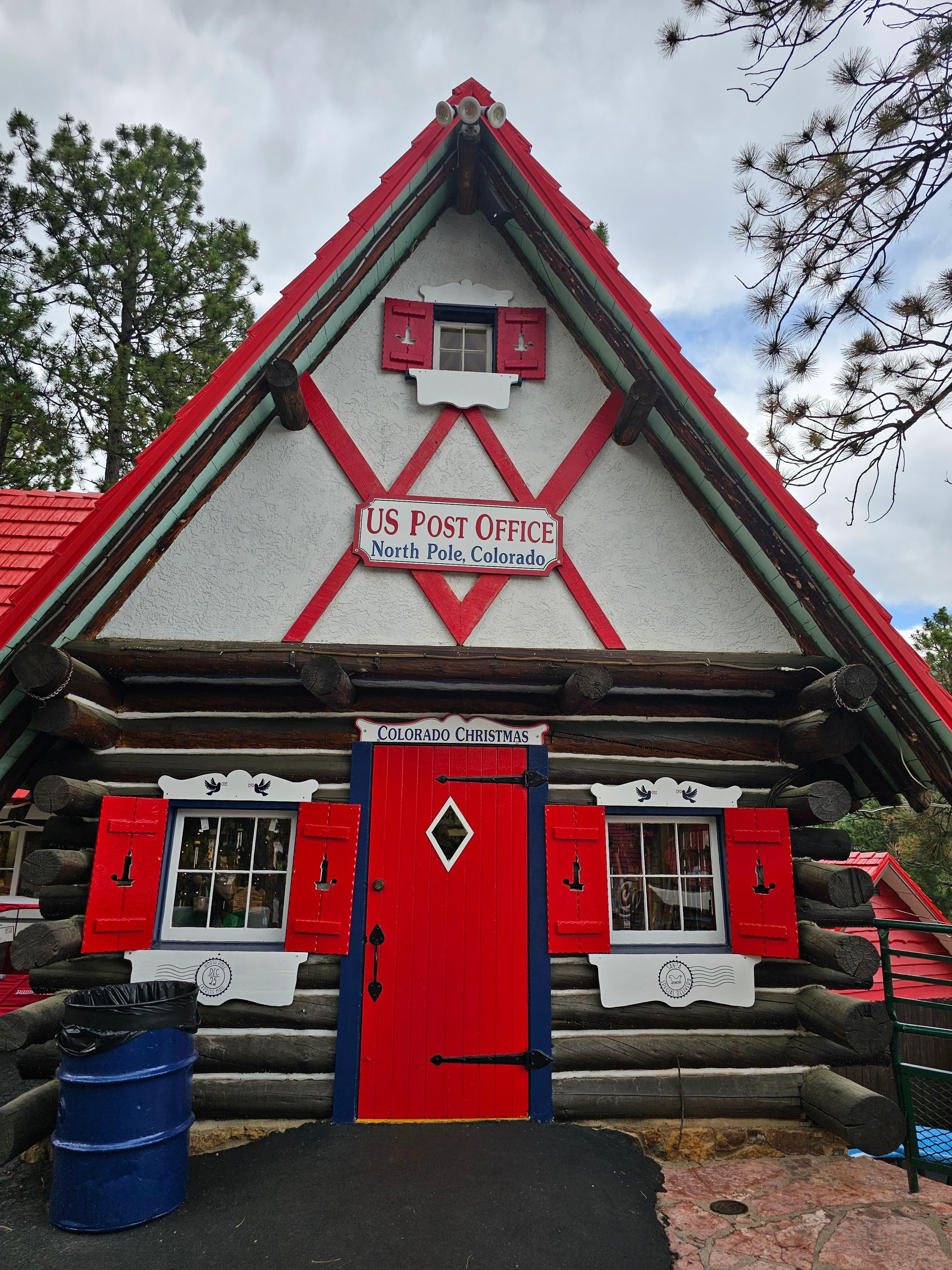 US Post Office, North Pole, Colorado — red and white log building with "Colorado Christmas" sign — LOVING LIFE HAVING FUN Brinkley Z3400