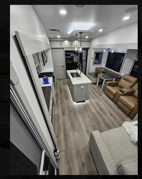 Brinkley Z3400 living room with sofa, open overhead cabinets and LED accent lighting