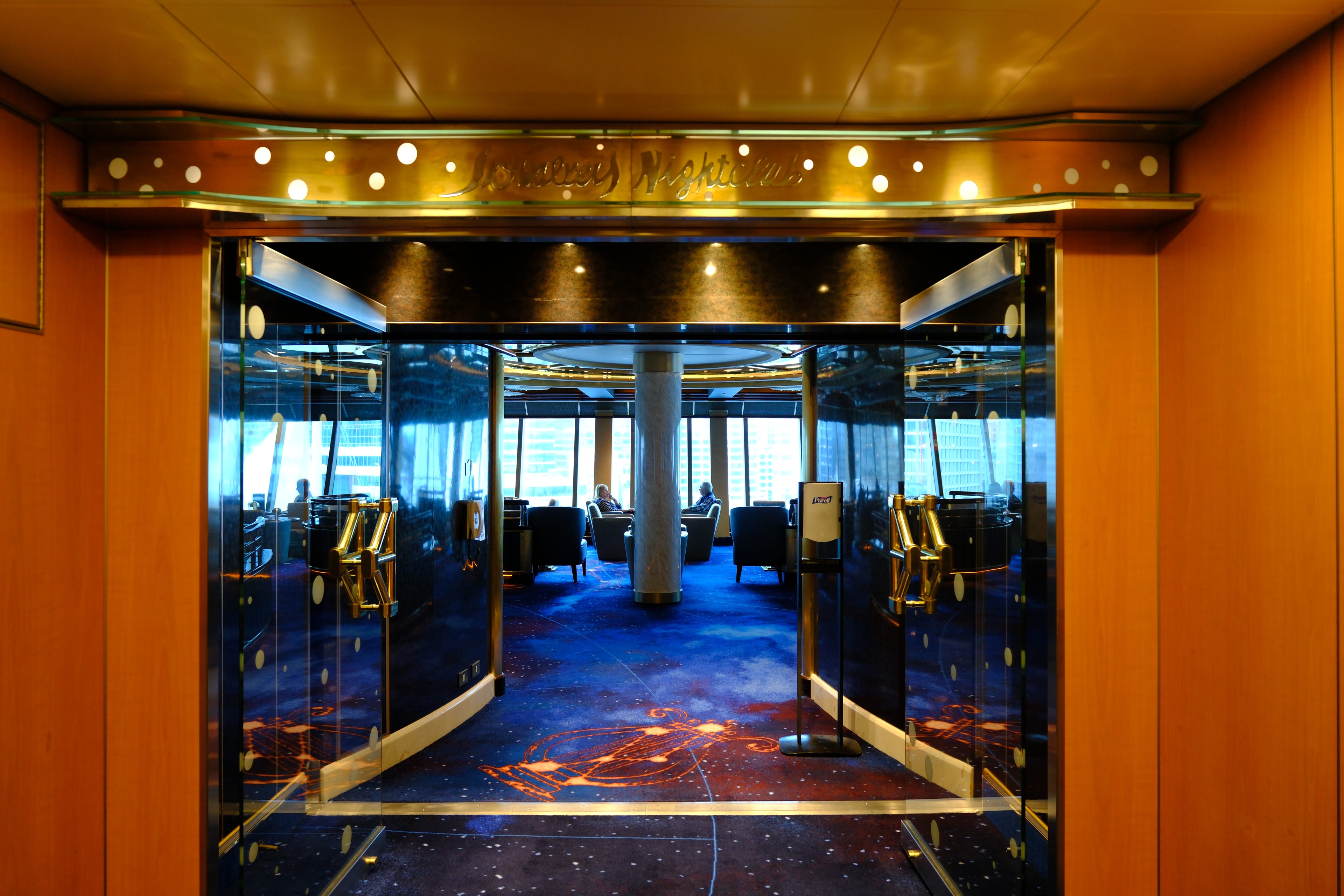Skywalkers Nightclub interior on the Emerald Princess — the signature galaxy-patterned carpet, gold railings, and star-studded ceiling of the iconic stern nightclub