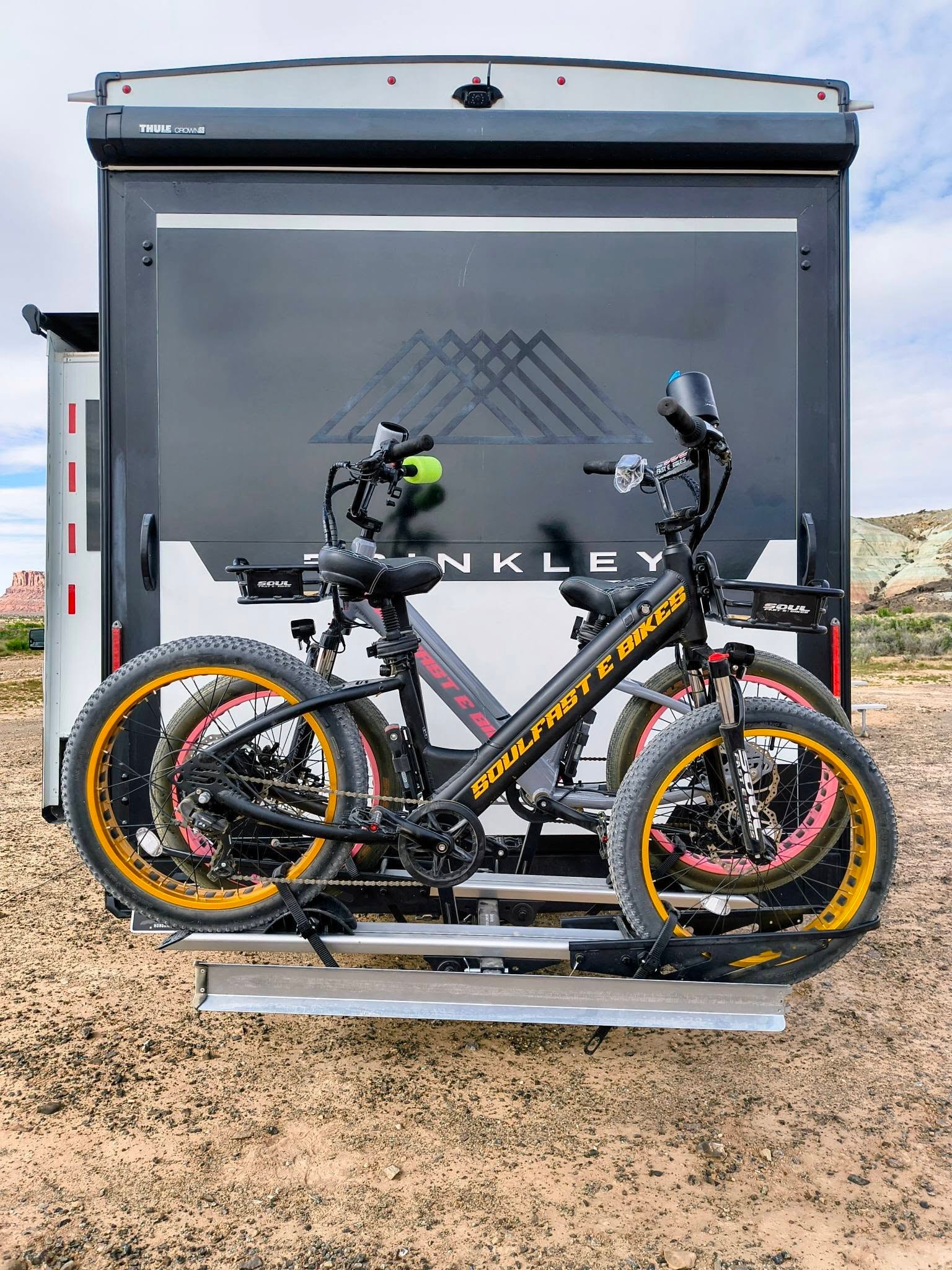 Both Soul Fast e-bikes loaded on the rear rack of the Brinkley in canyon country