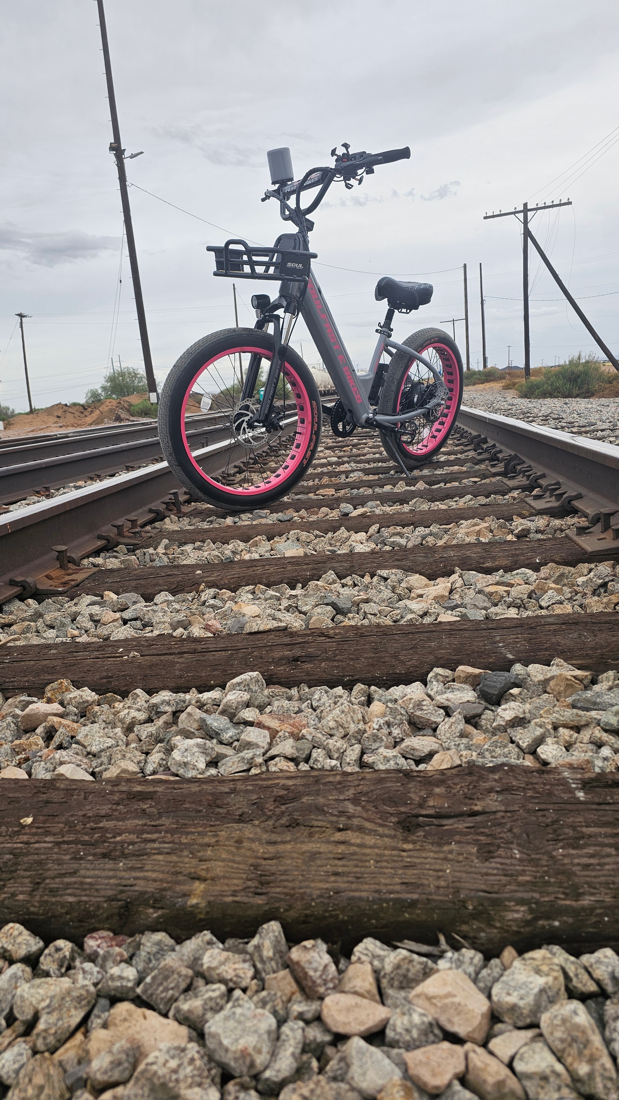 Pink Soul Fast e-bike posed on railroad tracks