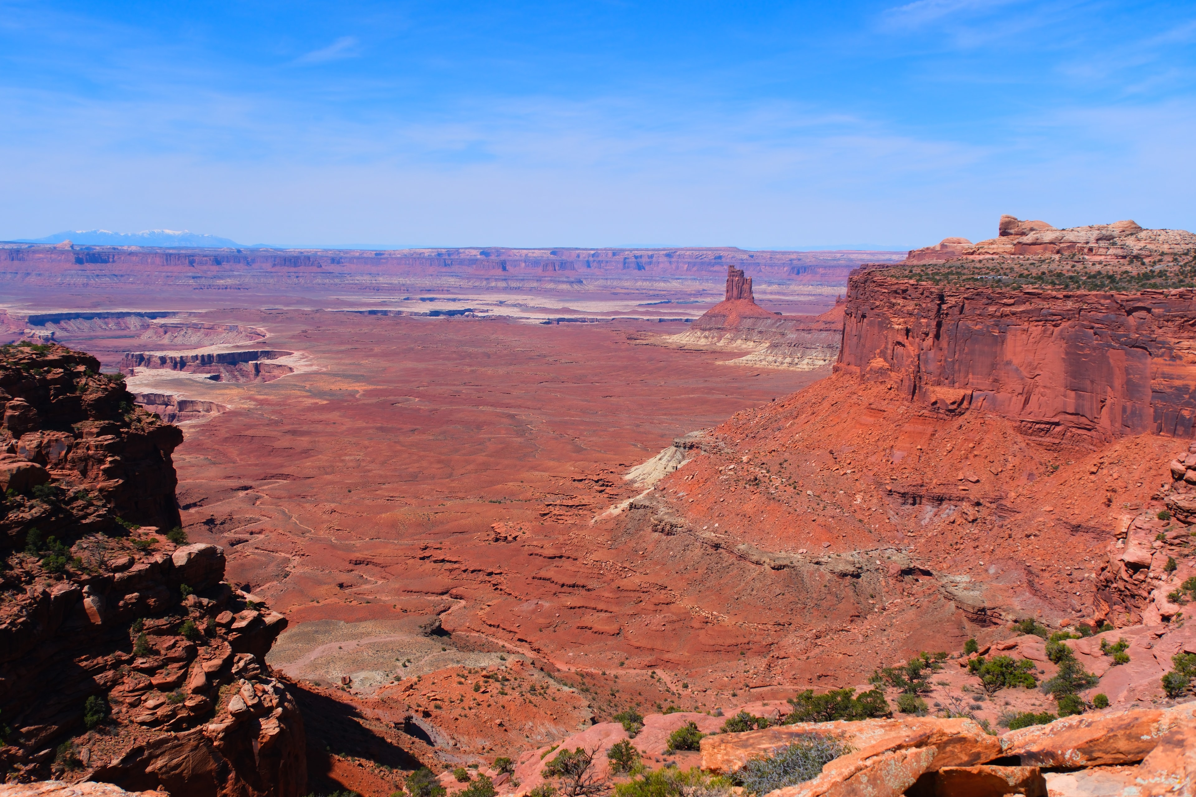 Vast Island in the Sky panoramic with canyon floor White Rim Road visible La Sal Mountains and deep blue sky at Canyonlands National Park Utah