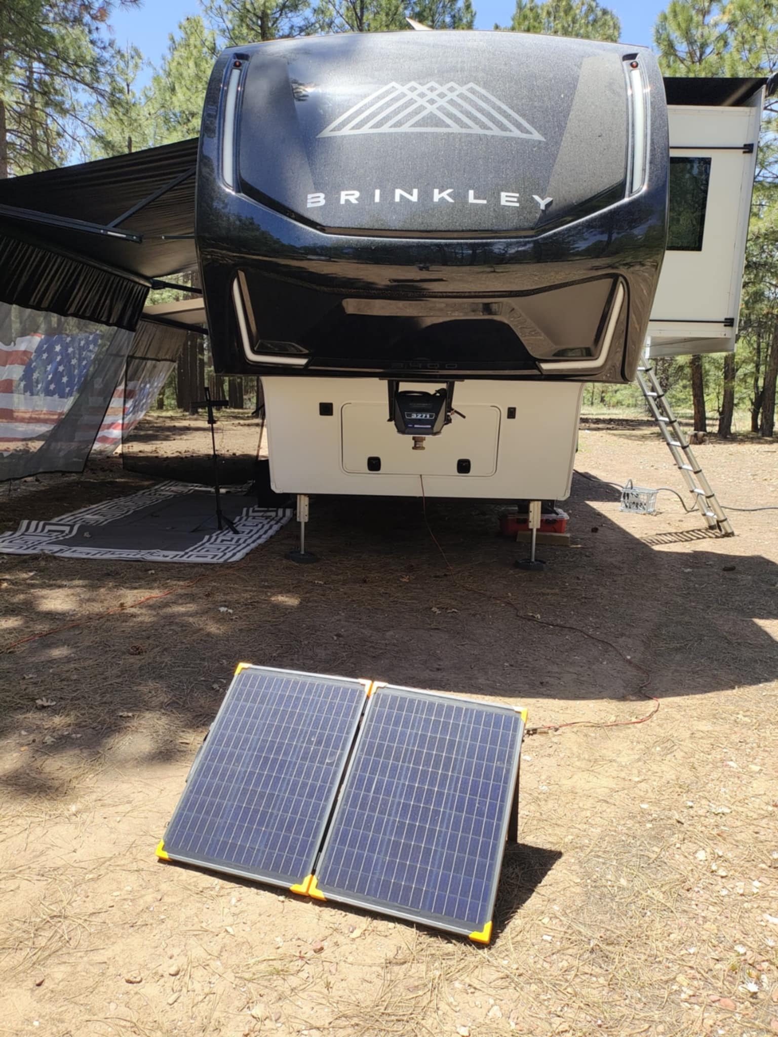 Portable solar panel in front of the Brinkley Z3400 in the pines