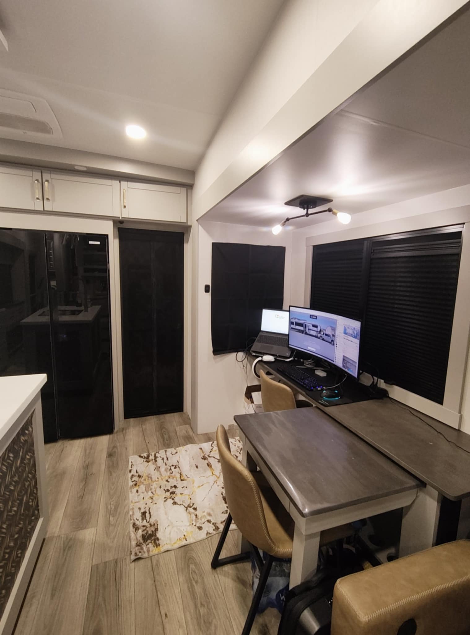 Joe's dual monitors glowing at night in the Brinkley Z3400 — laptop, curved monitor, and RGB keyboard