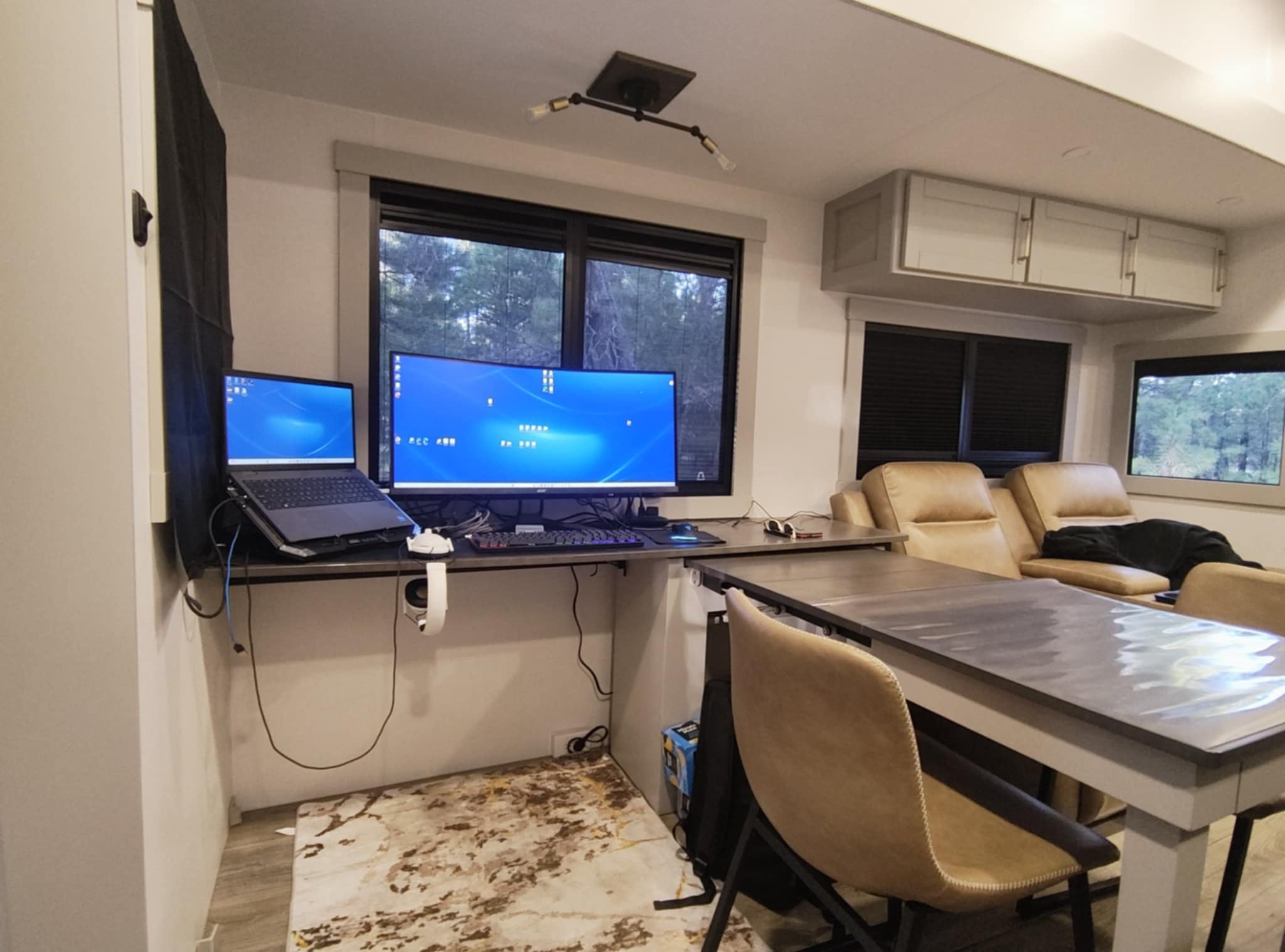 Joe's dual-monitor workstation lit up at night in the Brinkley Z3400 — wide view showing the full office setup